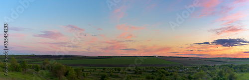 panorama of a blue-pink sunset with clouds of pink hues. sunset on the horizon. photo for the banner. space for text.