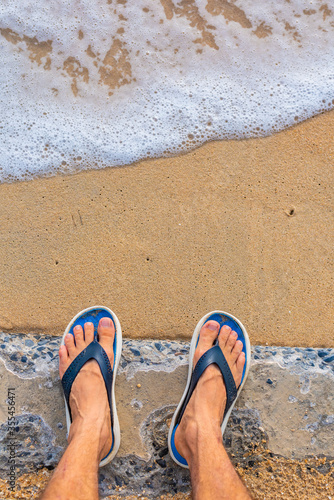 slippers on the beach, access to the sea from the hotel, the paradise island of Koh Samui in Thailand, slates in the sand, the beach season in the tropics, holidays in Asia