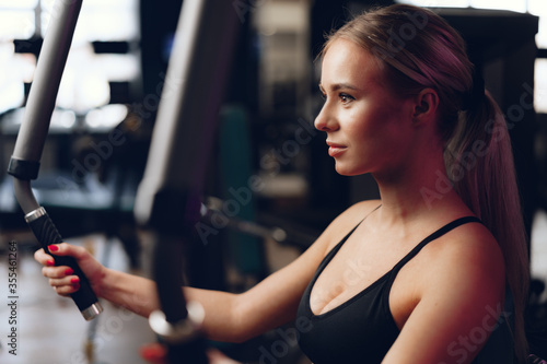Young caucasian blonde woman training hands in a gym
