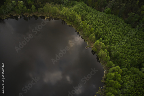 Obraz na płótnie A drone photo of an apple orchard at sunset. Fruit trees with flowers, spring time. Rural scenery, organic farming w salonie