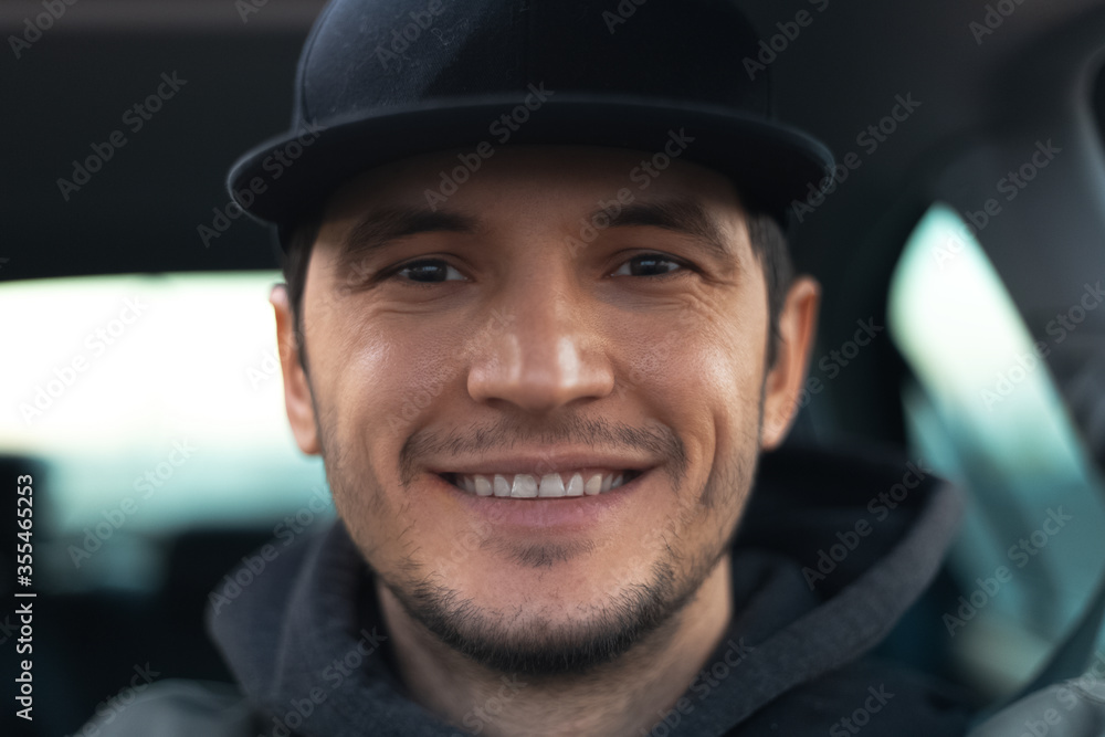 Close-up portrait of young smiling guy inside car. Close-up portrait of young smiling guy inside car.