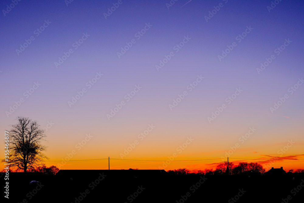 Fototapeta premium Countryside Landscape Under Scenic Colorful and dramatic Sky At Sunset or sunrise