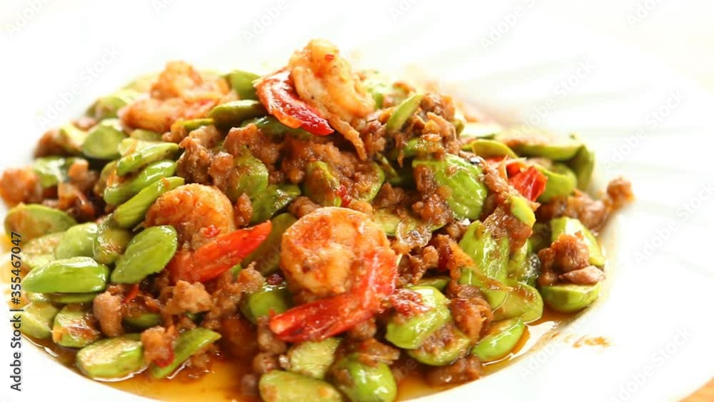 Stir fried bitter beans with shrimp in plate , Thai famous food Stir fried bitter beans with shrimp in plate , Thai famous food