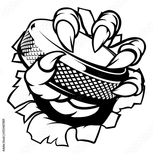 A monster claw or hand holding an ice hockey puck in its talons