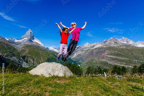 Mother and daughter on top of a mountain. The concept of travel, lifestyle © Angelov
