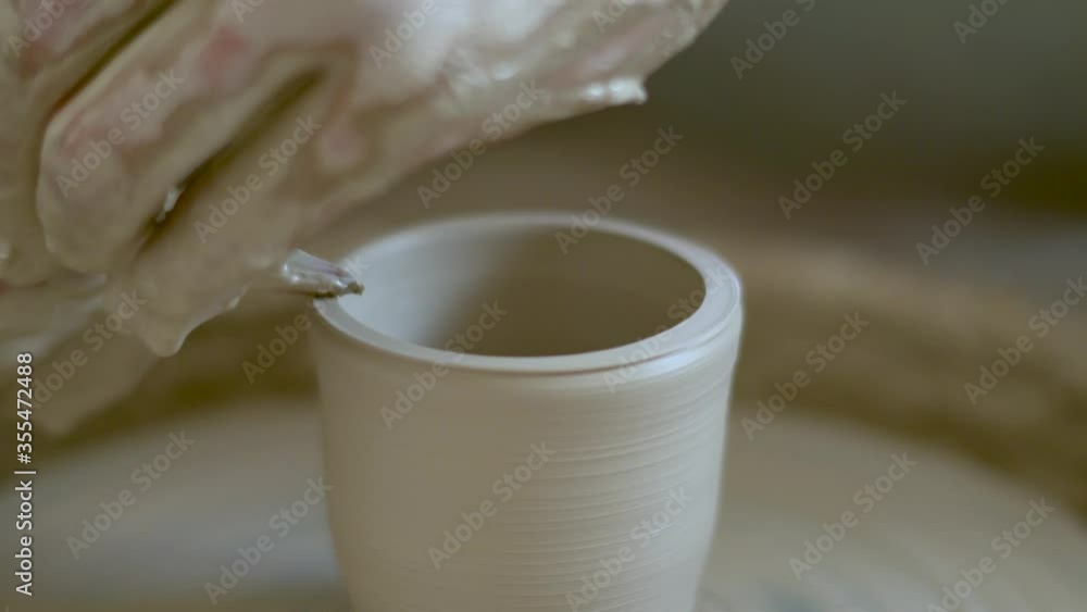 The manufacture of ceramics. Man sculpts from clay on pottery wheel. The manufacture of ceramics. Man sculpts from clay on pottery wheel.
