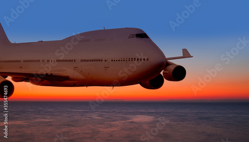 Passenger airplane in the sky at sunset 