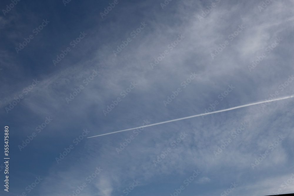 Airplanes leaving diagonal trace on a clear blue sky. Plane trail concept, traveling environmental issues Airplanes leaving diagonal trace on a clear blue sky. Plane trail concept, traveling environmental issues