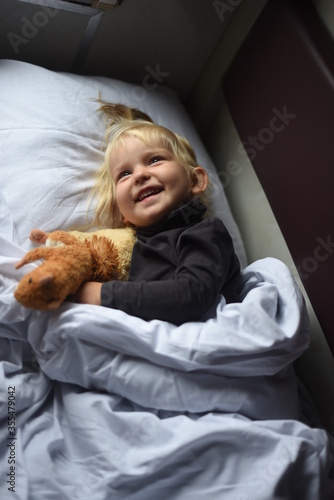 child sleeping in train with toy