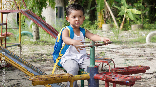 Cute Asian boy 2 year old on the way trip out door concept.