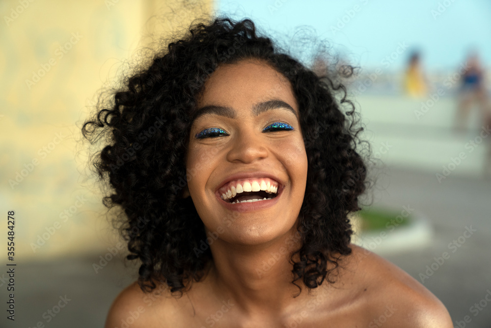Portrait of a beautiful brazilian woman smiling to the camera outdoors Portrait of a beautiful brazilian woman smiling to the camera outdoors