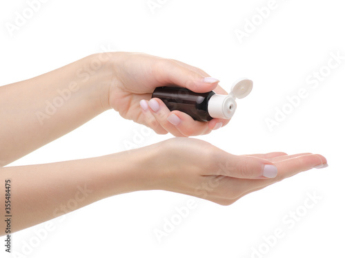 Cosmetic brown bottle beauty in hand on white background isolation