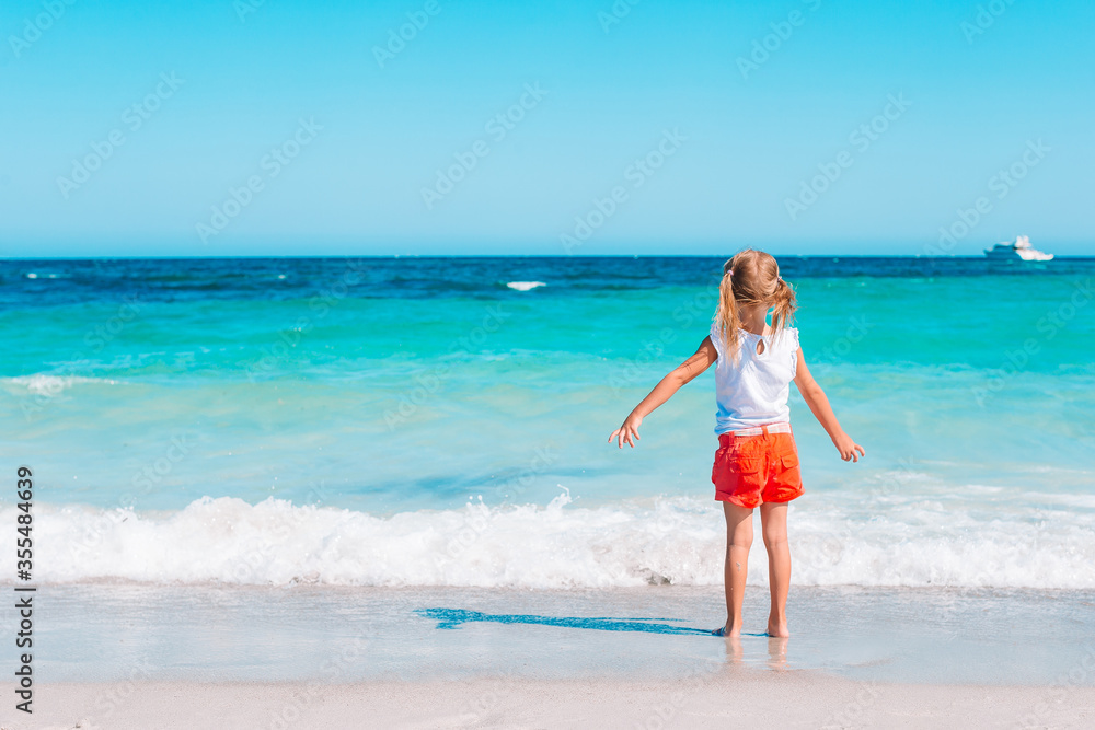 Adorable little girl at beach during summer vacation Adorable little girl at beach during summer vacation