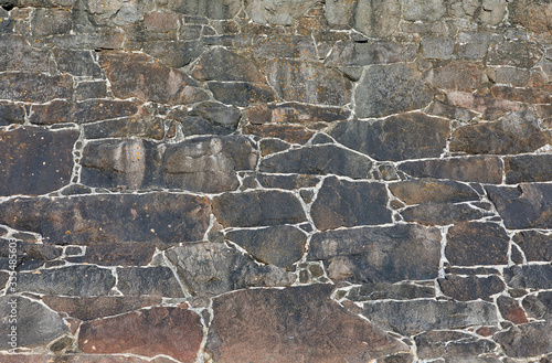 Image of a granite stone coastal wall. Textured background. photo