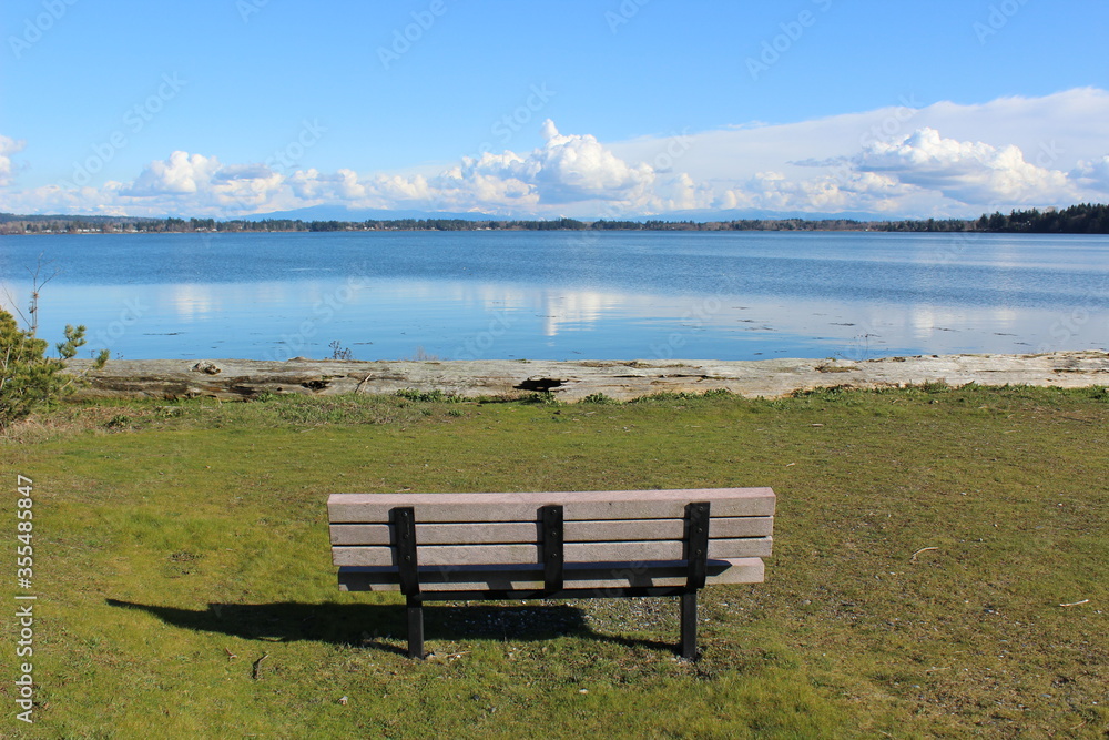 An empty bench with a beautiful bay view 