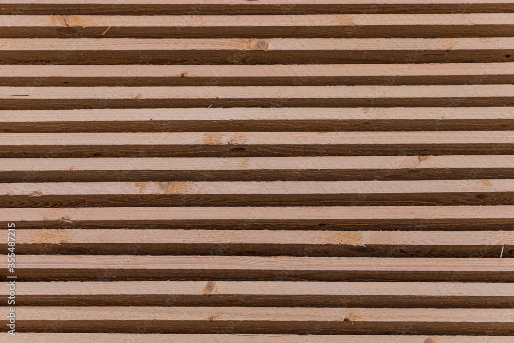 Piles of wooden boards in the sawmill, planking. Warehouse for sawing boards on a sawmill outdoors. Wood timber stack of wooden blanks construction material. Industry. Piles of wooden boards in the sawmill, planking. Warehouse for sawing boards on a sawmill outdoors. Wood timber stack of wooden blanks construction material. Industry.