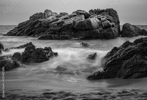 Long exposure black and white photo in Cala Boadella on a summer day 