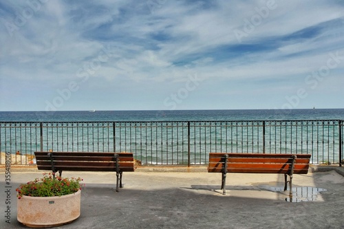 Empty benches facing the sea