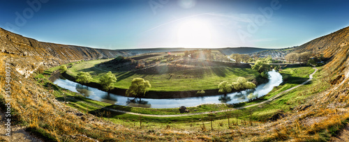 Fototapeta Naklejka Na Ścianę i Meble -  Beautiful landscape of summer hills with river in Moldova, Old Orhei. Zigzag river flows between valleys with willow trees and rocks. Travel background panorama, Europe