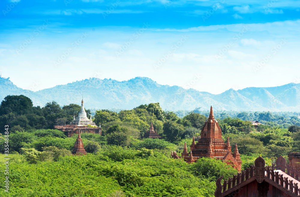 View of Ancient Pagodas inside a Forest in Bagan, Myanmar. Background a Mountain Landscape, Copy space for text