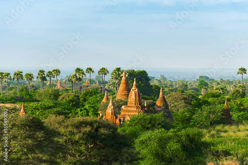View of Ancient Pagodas in Bagan  Myanmar. Beautiful Morning Time with Blue Sky  Palm Trees 