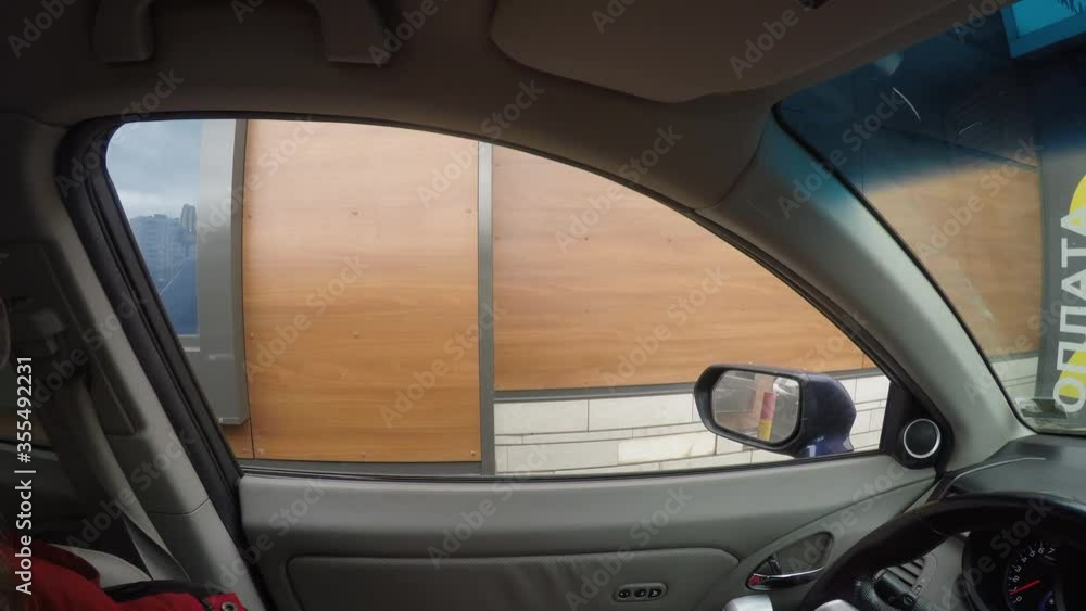 View of wall through window of moving car. Car is in line. View of wall through window of moving car. Car is in line.