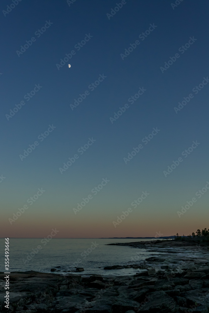 Moon over the shore. Blue sky after sunset. Moon over the shore. Blue sky after sunset.