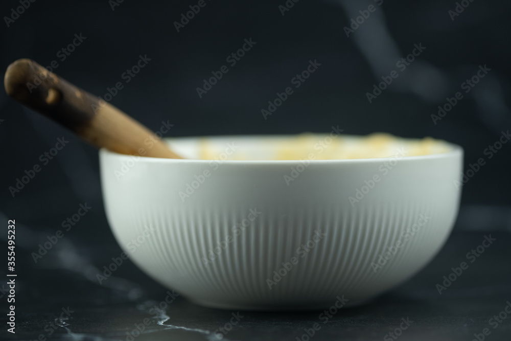 White bowl and wooden spoon White bowl and wooden spoon