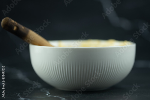 White bowl and wooden spoon