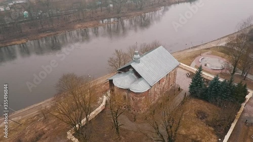 Ancient Orthodox Church in Grodno, Belarus. Kolozha. Flight by drone counterclockwise. Next to the river. Autumn. View from a bird's-eye view photo