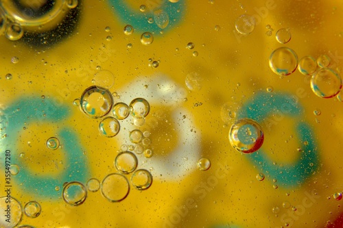 Air bubbles in water against the background of a yellow background with green accents