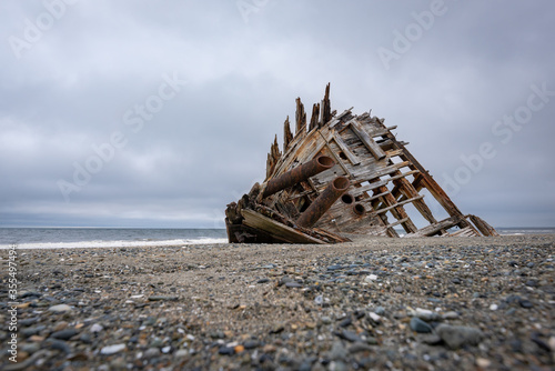 The famous and popular Pesuta Shipwreck on a cloudy day giving it a dark and dramatic effect. The wreck is located on the East Beach in Naikoon Provincial Park, Haida Gwaii British Columbia, Canada