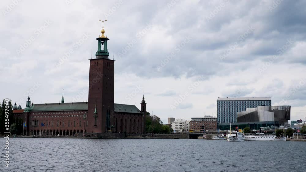 Time lapse of boat traffic on waterfront of landmark town hall building in Stockholm Time lapse of boat traffic on waterfront of landmark town hall building in Stockholm