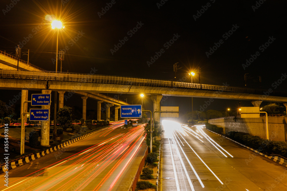 Light trail of the Delhi Metro Rail passing over Dhaula Kuan ring road.