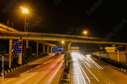 Light trail of the Delhi Metro Rail passing over Dhaula Kuan ring road.