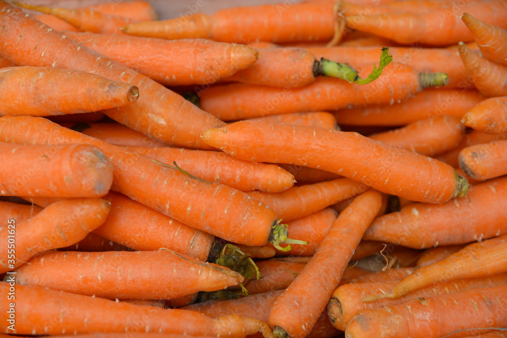 Carrots for sale on market stall, loose and organic. Carrots for sale on market stall, loose and organic.