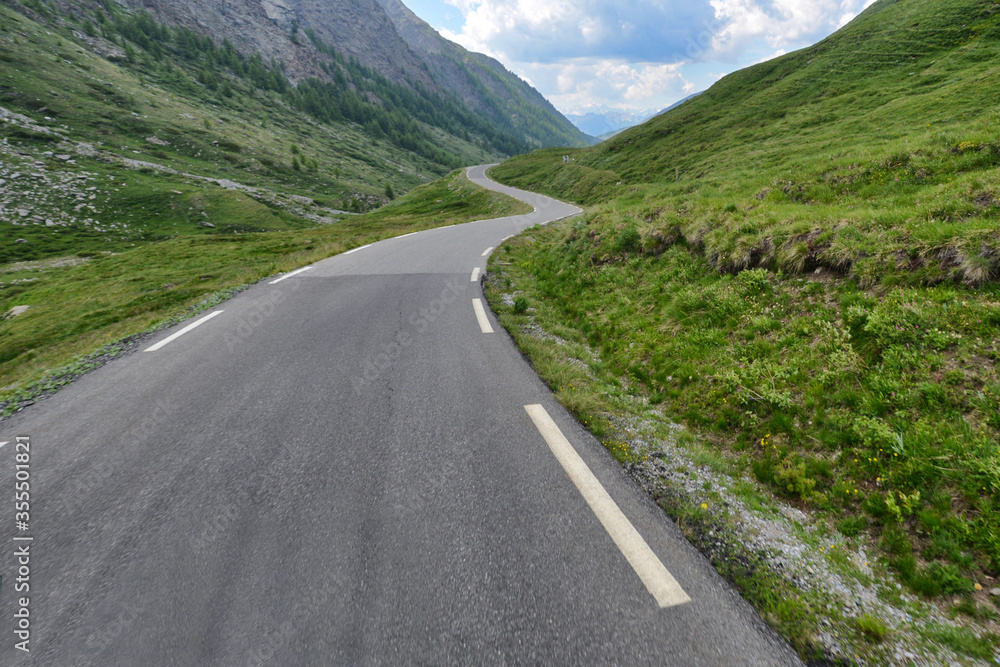Landscape empty tourist path iconic curved road between mountais with cloudy sky Landscape empty tourist path iconic curved road between mountais with cloudy sky