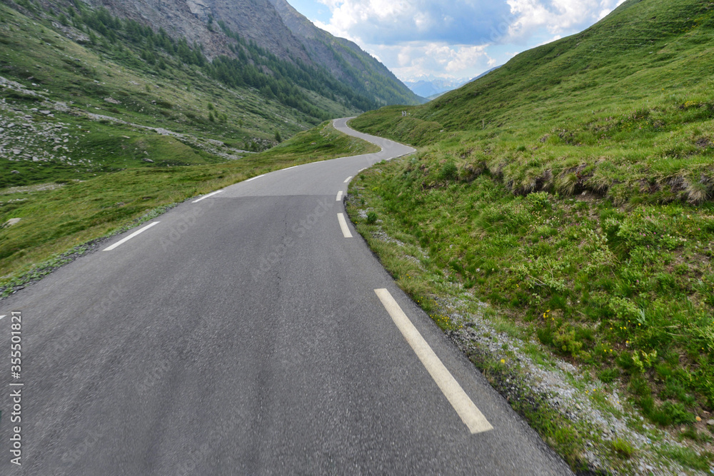 Landscape empty tourist path iconic curved road between mountais with cloudy sky