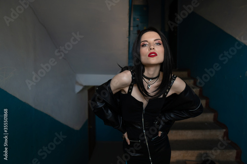 Bilde på lerret Half-naked girl in a black leather jacket posing in the porch