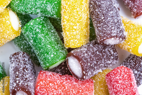 Colorful sour candy licorices. Sweet snack, gummies, jellybeans, gumdrop, gummy candy, unhealthy food. Isolated on white background