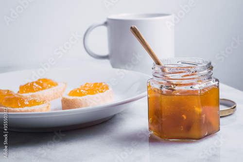 breakfast prepared with toast with jam and herbal tea