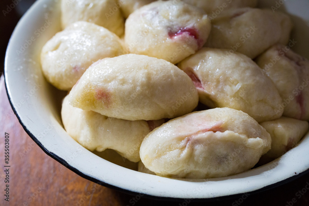 The process of cooking traditional vareniki - textured background. Rural East European cuisine. Dumplings with cottage cheese. Traditional dumplings, pierogi, varenyky The process of cooking traditional vareniki - textured background. Rural East European cuisine. Dumplings with cottage cheese. Traditional dumplings, pierogi, varenyky