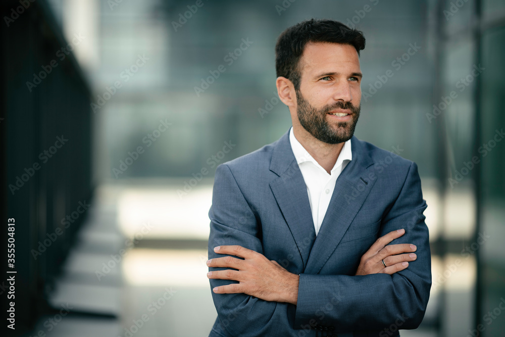 Fototapeta premium Portrait of handsome businessman. Young businessman in blue suit.