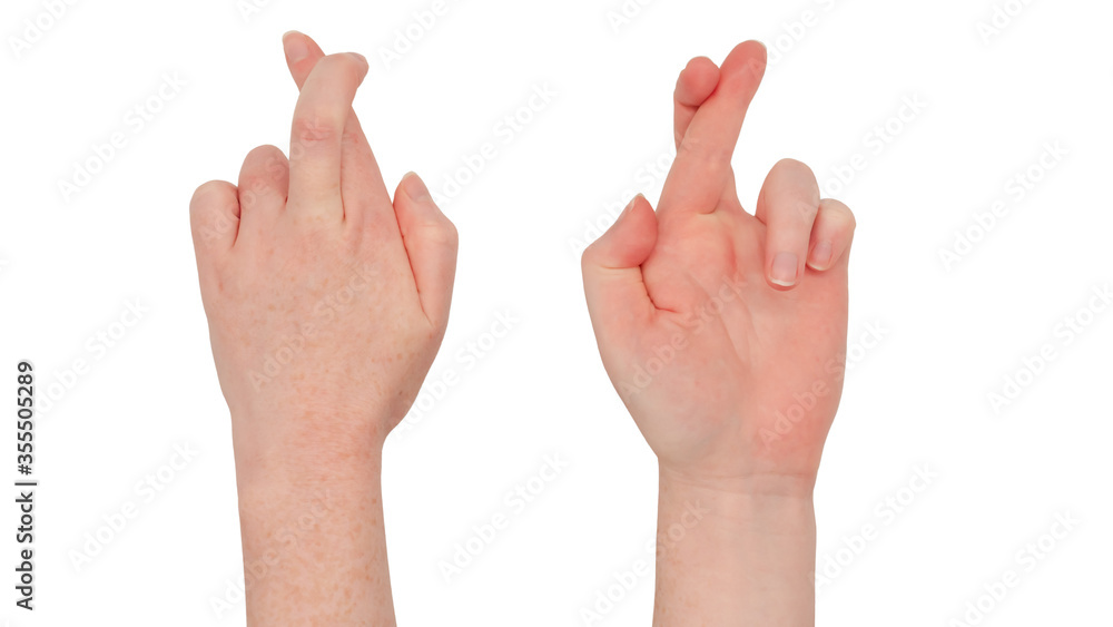 Freckled white hands. Isolated woman's hand in a fingers crossed gesture, little and ring fingers tucked in. Front and back Freckled white hands. Isolated woman's hand in a fingers crossed gesture, little and ring fingers tucked in. Front and back