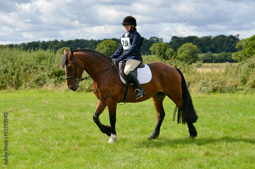 Smartly turned out horse and rider competing in a dressage competition outdoors in rural Shropshire 