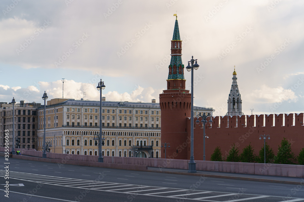 Fototapeta premium Photography of the one of the Kremlin Towers. Mosow cityscape. Sky with white clouds as background. Natural city pattern. Almost no people,no traffic. Coronavirus pandemic