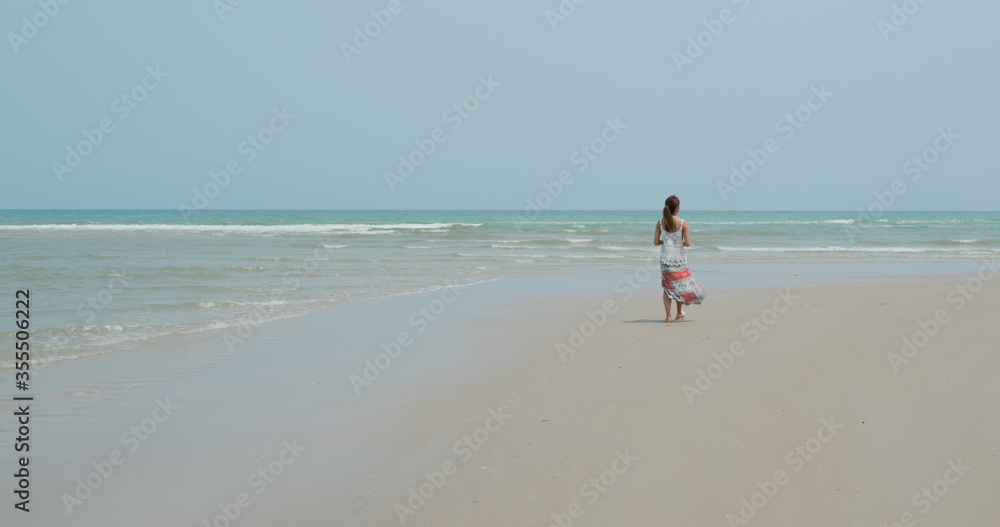 Woman walk in the beach