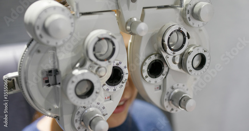 Woman check her eye at beauty salon