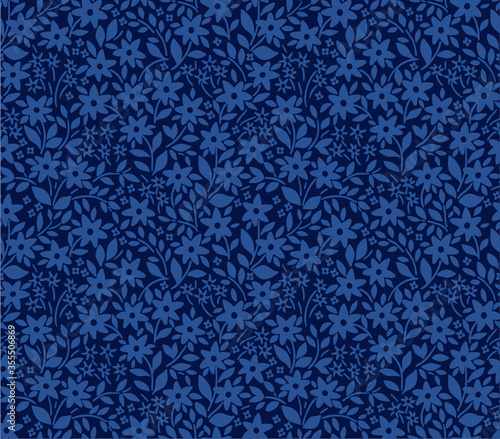 Seamless floral pattern for design. Small blue flowers and leaves. Dark blue background. Modern floral texture.The elegant the template for fashion prints.