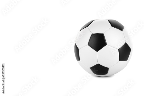 Classic black and white soccer ball with little shadow isolated on a white background. Place for text. Traditional soccer ball symbol  real studio photo.